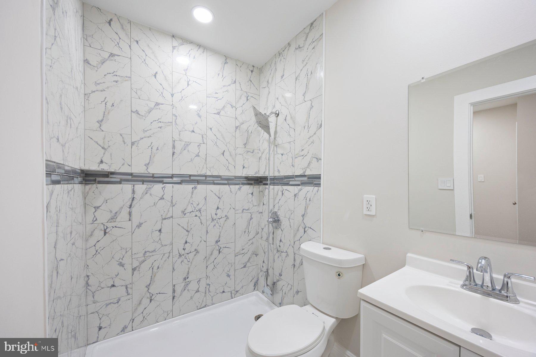 117 Collins Avenue Baltimore, MD 21229 - Photo 20 of 27 a bathroom with a sink a toilet and shower curtain