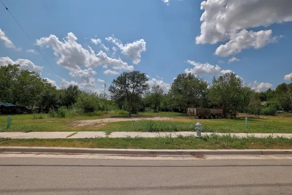 a view of a house and a big yard