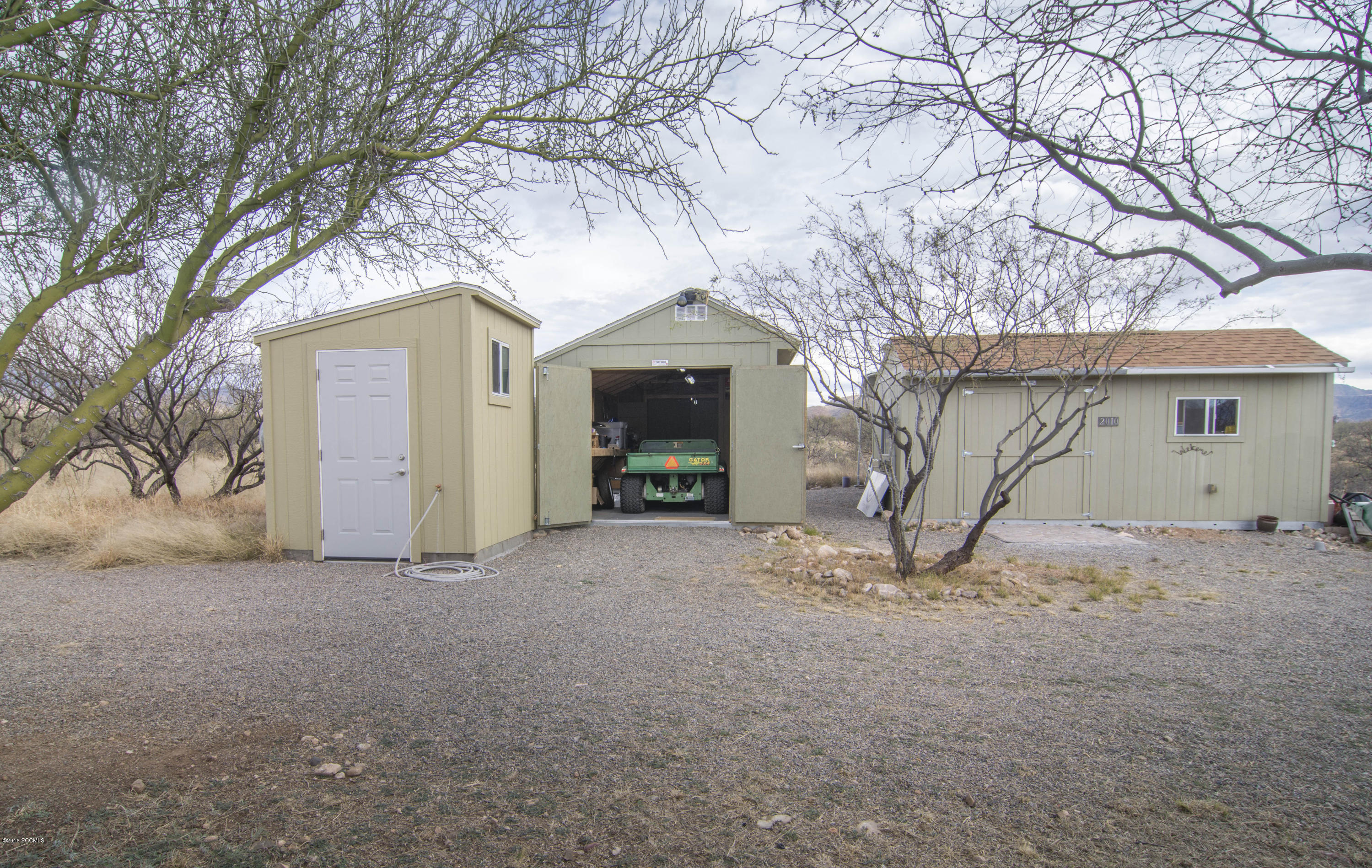 66 Camino Nacozari Rio Rico, AZ 85648 - Photo 50 of 55 a front view of a house with a yard and garage