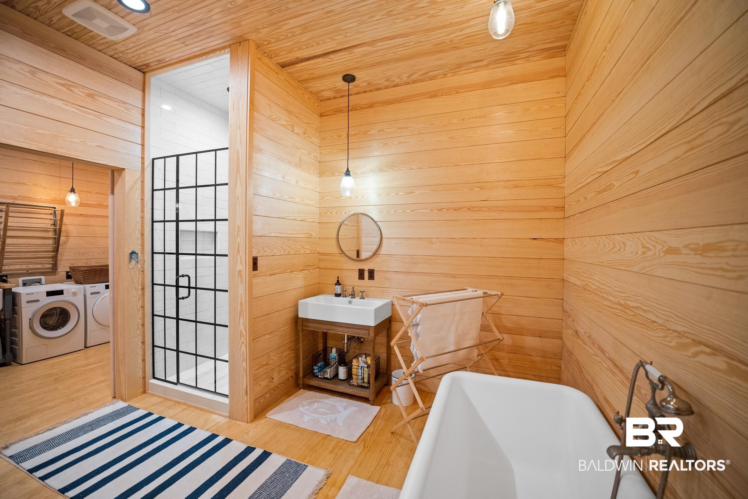 30671 Magnolia Street Elberta, AL 36530 - Photo 54 of 68 Full bath featuring wooden ceiling, a sink, wood walls, a soaking tub, and washer and dryer