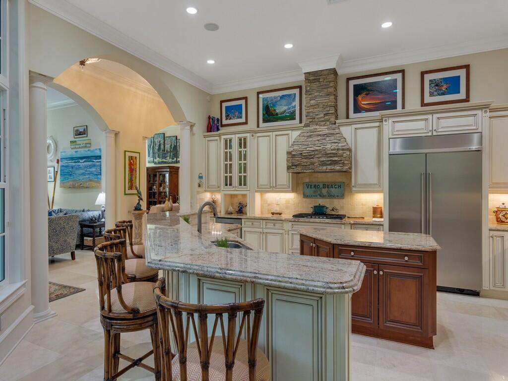 400 Oceanview Lane Vero Beach, FL 32963 - Photo 20 of 59 a kitchen with stainless steel appliances granite countertop a stove and a refrigerator
