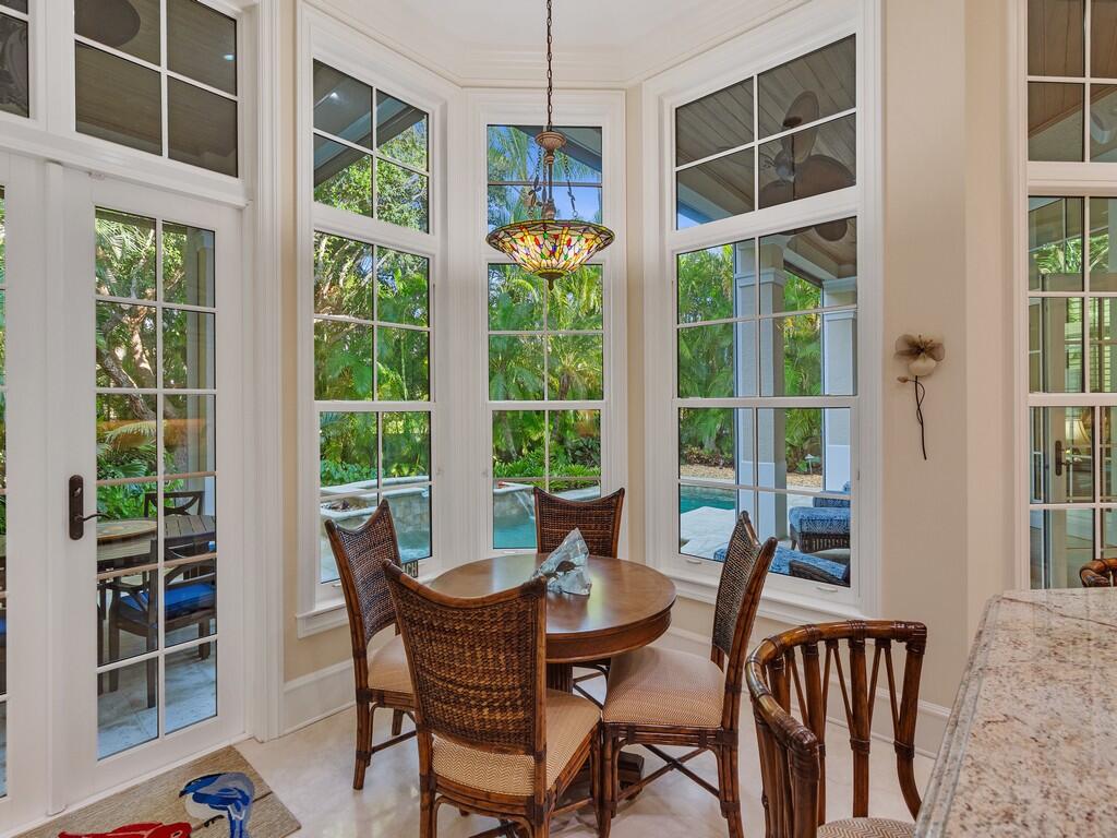 400 Oceanview Lane Vero Beach, FL 32963 - Photo 21 of 59 a dining room with wooden floor windows and outdoor view