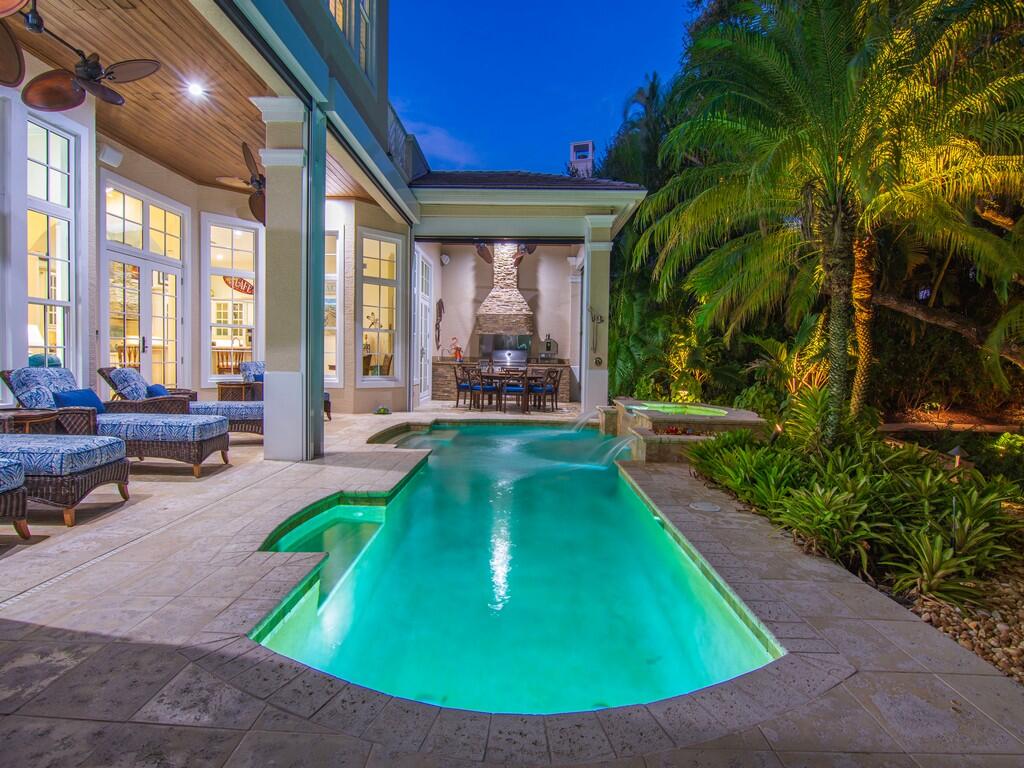 400 Oceanview Lane Vero Beach, FL 32963 - Photo 4 of 59 a view of a swimming pool with lawn chairs and floor to ceiling window