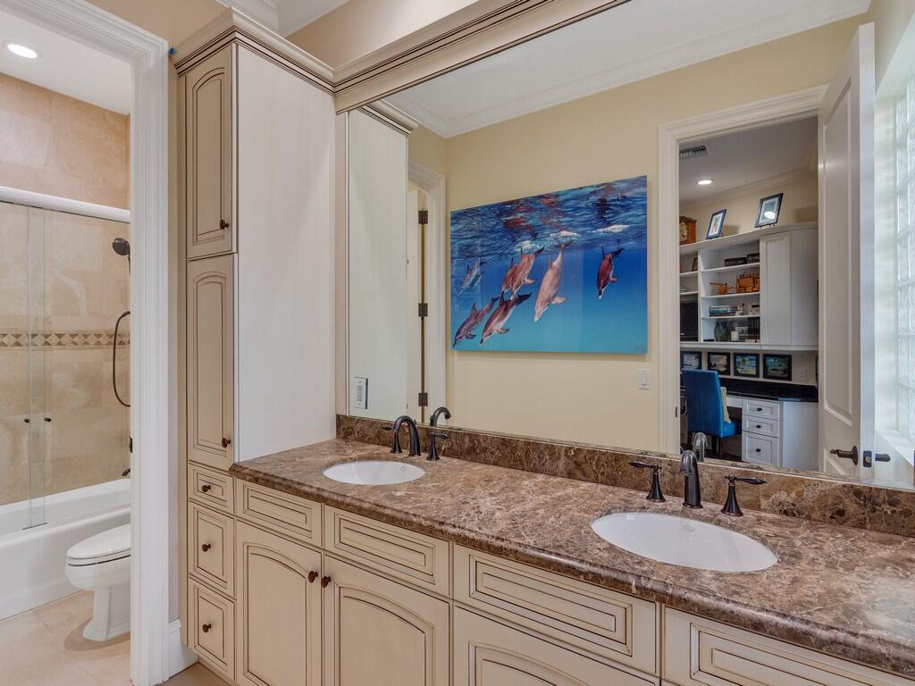 400 Oceanview Lane Vero Beach, FL 32963 - Photo 45 of 59 a bathroom with a granite countertop sink mirror vanity and toilet