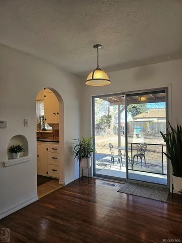 a view of a hallway with wooden floor and a fireplace