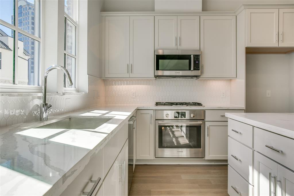 615 Baugh Drive Irving, TX 75039 - Photo 1 of 1 a kitchen with stainless steel appliances granite countertop a stove and a sink