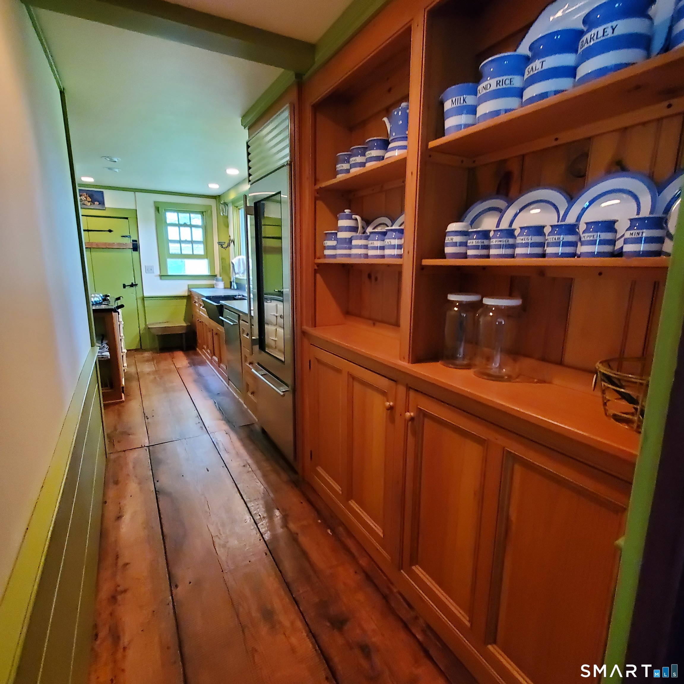 24 Ayer Road Franklin, CT 06254 - Photo 11 of 15 Custom honey pine cabinetry and wide board flooring in the kitchen.