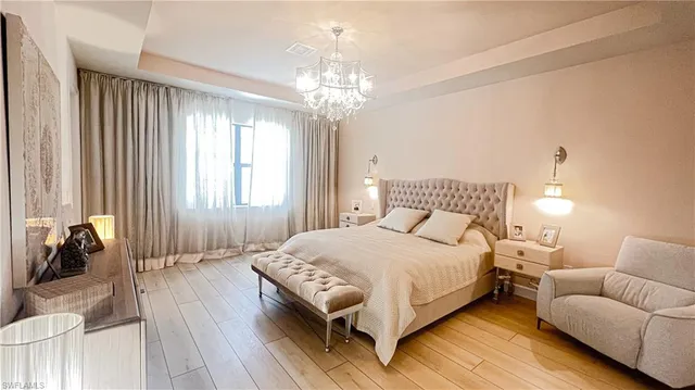 a spacious bedroom with a bed and a couch