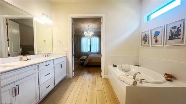 a spacious bathroom with a double vanity sink and a mirror
