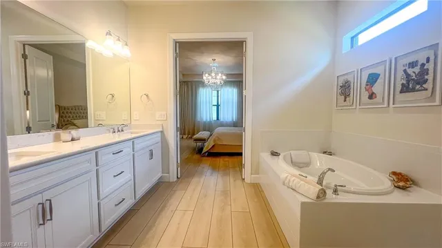 a spacious bathroom with a double vanity sink and a mirror
