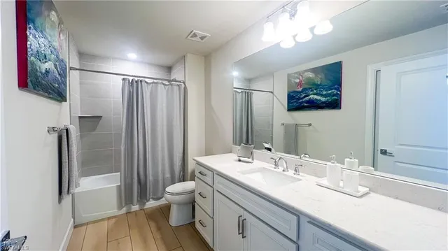 a bathroom with a double vanity sink mirror and shower