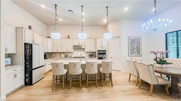 a large kitchen with a table and chairs