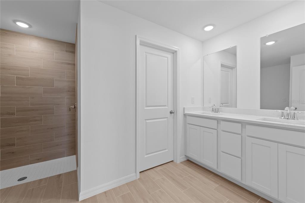 6285 Marcum Street Englewood, FL 34224 - Photo 11 of 15 a bathroom with a double vanity sink and a mirror
