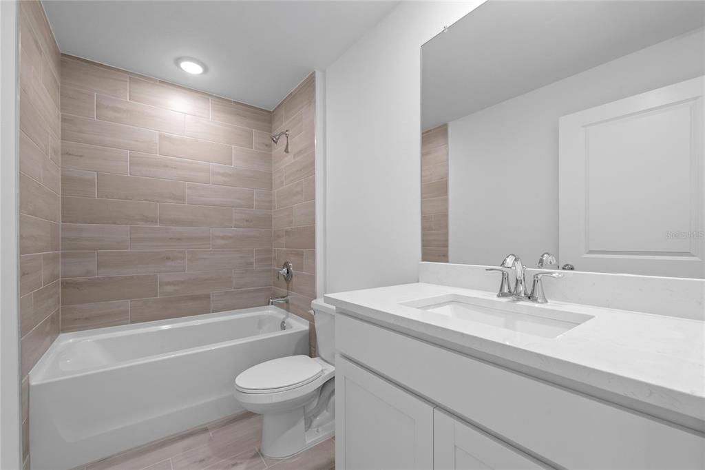 6285 Marcum Street Englewood, FL 34224 - Photo 12 of 15 a bathroom with a sink a toilet and a bathtub