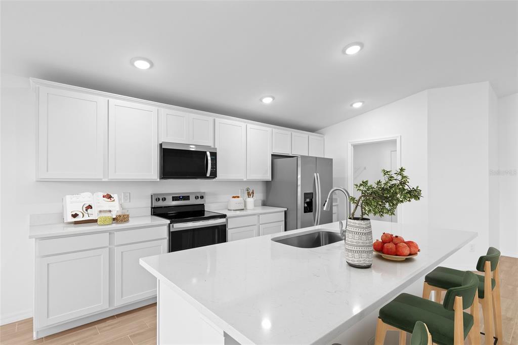 6285 Marcum Street Englewood, FL 34224 - Photo 5 of 15 a kitchen with stainless steel appliances a microwave sink refrigerator and cabinets