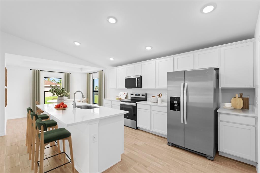 6285 Marcum Street Englewood, FL 34224 - Photo 6 of 15 a kitchen with refrigerator and furniture