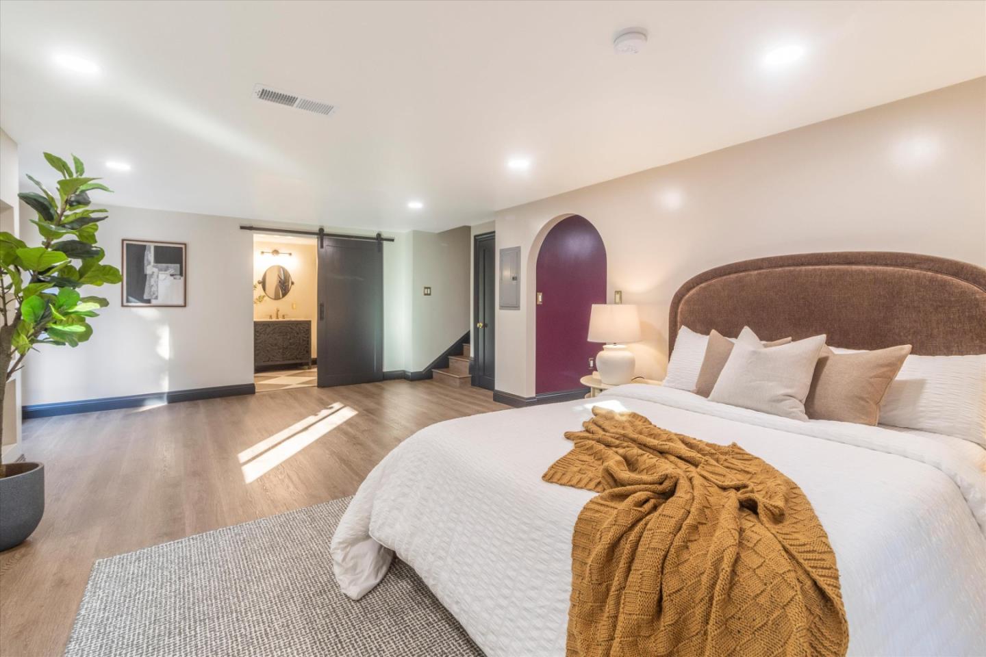 1821 Yale Drive Alameda, CA 94501 - Photo 41 of 74 a spacious bedroom with a bed and a potted plant