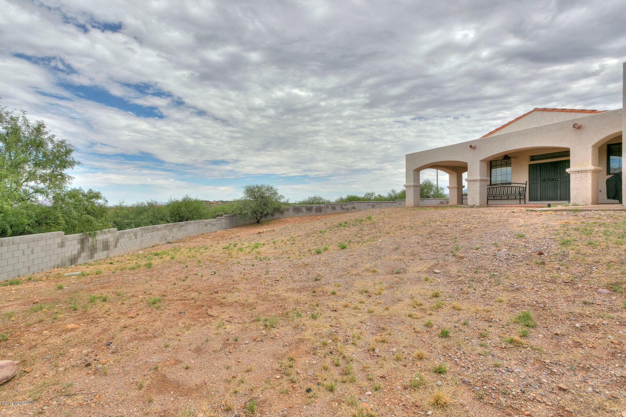 1648 Circulo Puerto Rio Rico, AZ 85648 - Photo 25 of 34 a front view of a house with a yard
