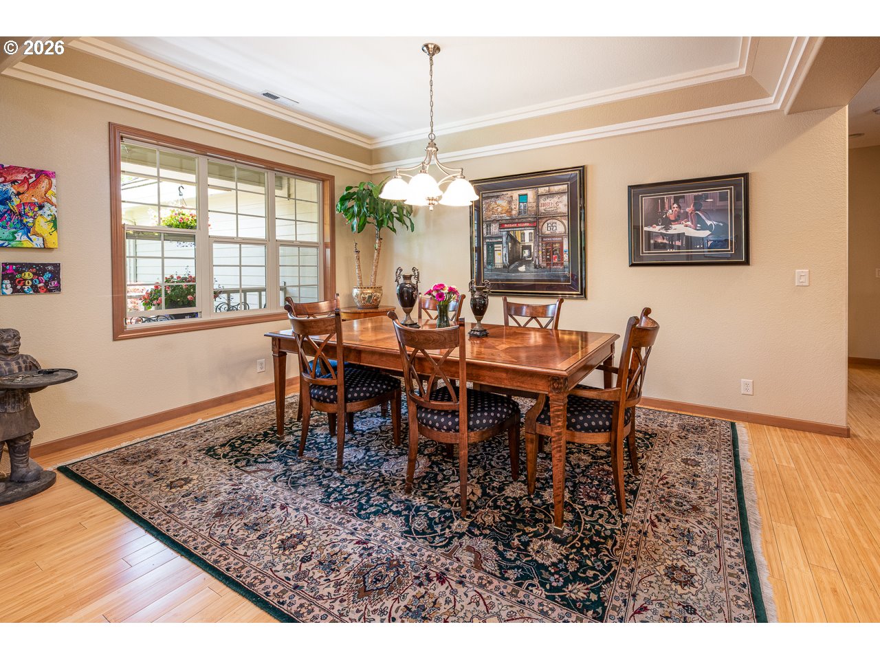 3381 Rosemont Way Eugene, OR 97401 - Photo 7 of 45 a view of a dining room and livingroom with furniture wooden floor a rug a painting and a chandelier