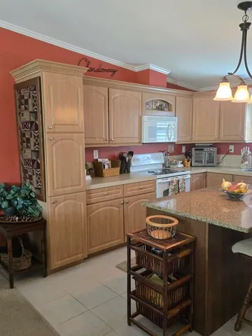 a kitchen with a sink appliances and cabinets