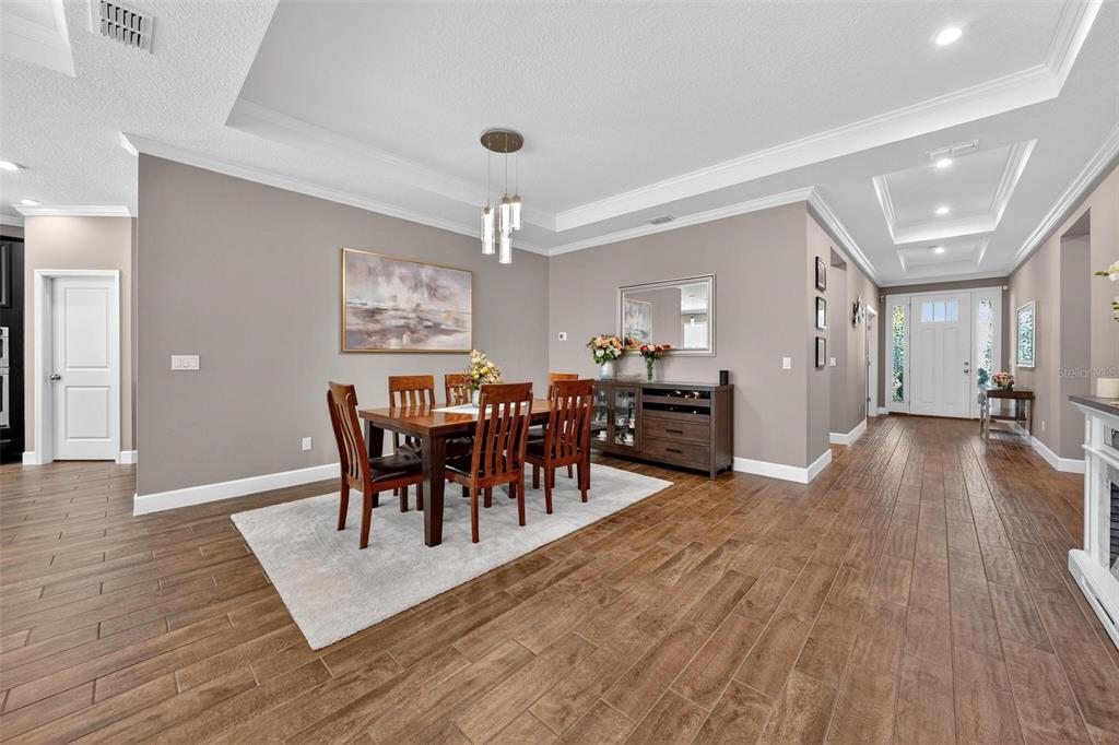 1235 Waterview Ridge Circle Apopka, FL 32703 - Photo 12 of 82 a view of a dining room with furniture and wooden floor