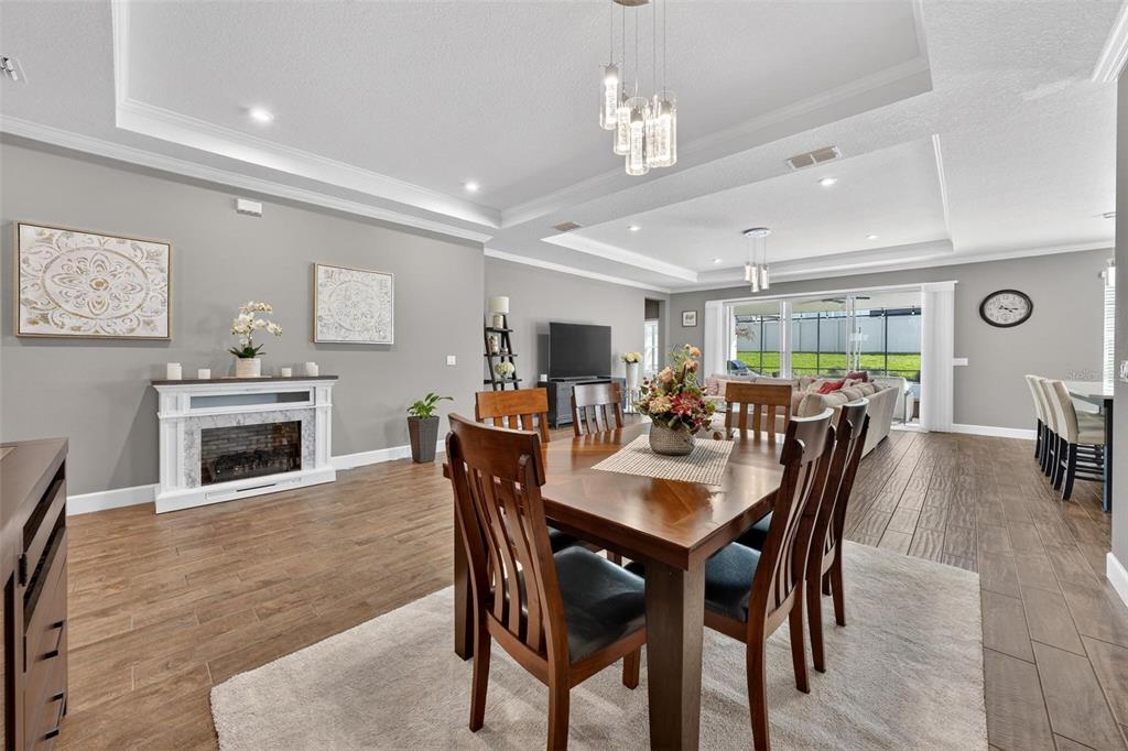 1235 Waterview Ridge Circle Apopka, FL 32703 - Photo 13 of 82 a view of a dining room with furniture and wooden floor