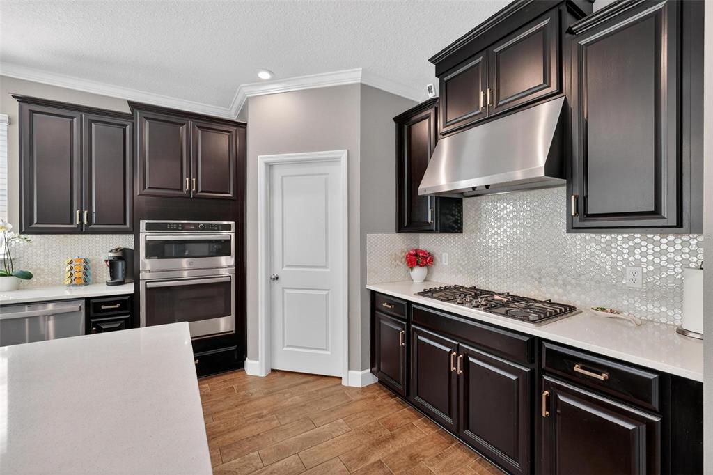 1235 Waterview Ridge Circle Apopka, FL 32703 - Photo 25 of 82 a kitchen with stainless steel appliances granite countertop a stove microwave and refrigerator