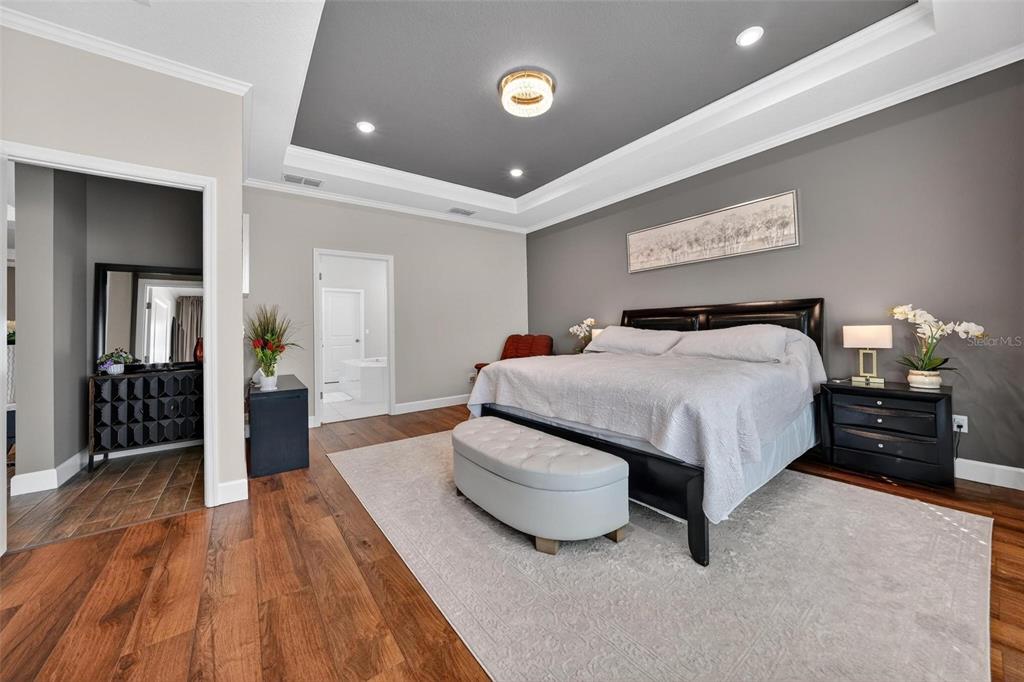 1235 Waterview Ridge Circle Apopka, FL 32703 - Photo 30 of 82 a spacious bedroom with a bed and wooden floor