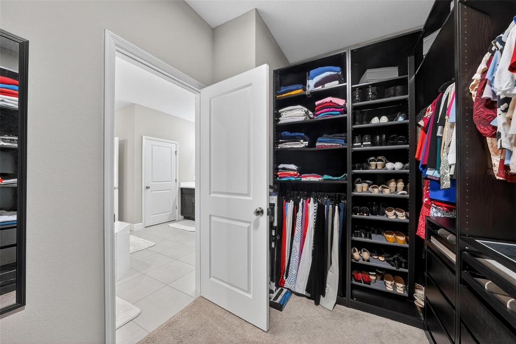 1235 Waterview Ridge Circle Apopka, FL 32703 - Photo 37 of 82 a view of walk in closet with clothes and shoes