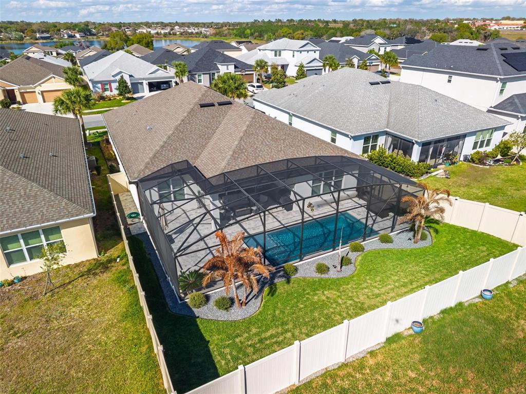 1235 Waterview Ridge Circle Apopka, FL 32703 - Photo 66 of 82 an aerial view of a house with swimming pool lawn chairs and large trees