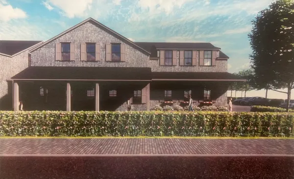 a front view of a house with lots of green space and porch