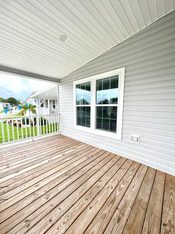 a view of a balcony with wooden floor