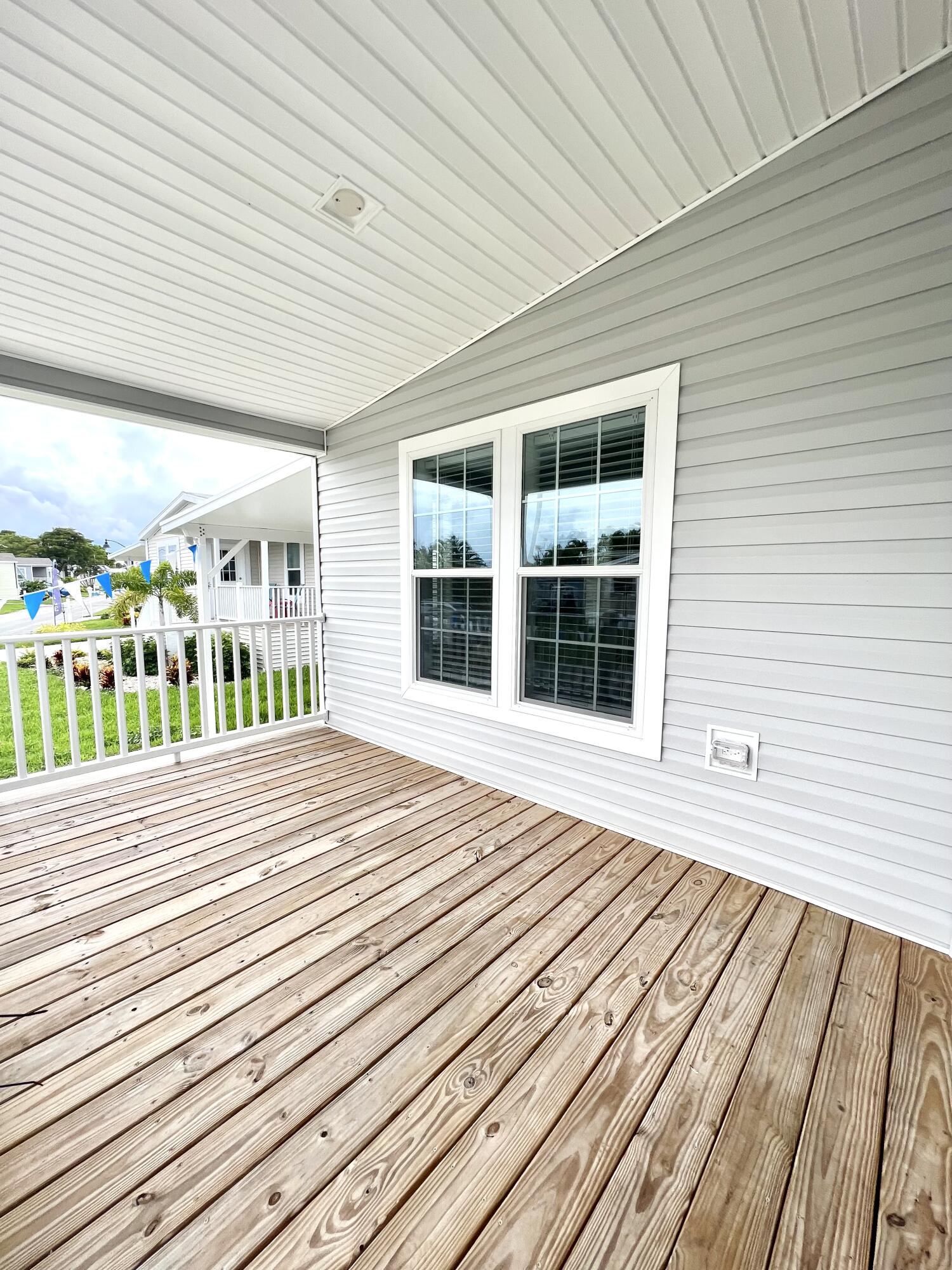 4099 74th Road North, Unit 409 West Palm Beach, FL 33404 - Photo 13 of 18 a view of a balcony with wooden floor