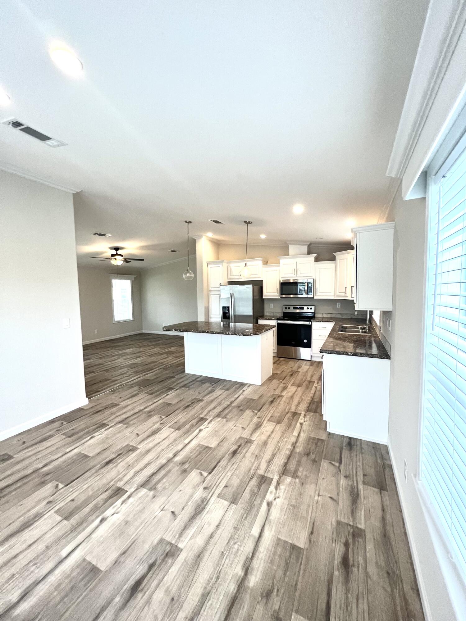 4099 74th Road North, Unit 409 West Palm Beach, FL 33404 - Photo 2 of 18 a view of kitchen and living room with wooden floor