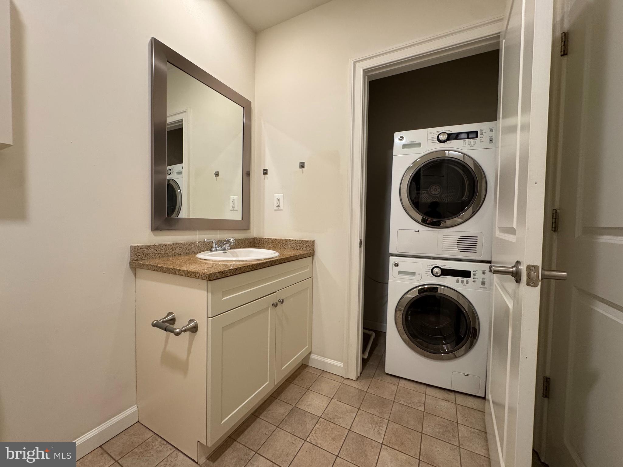 2040 Market Street, Unit 207 Philadelphia, PA 19103 - Photo 11 of 12 a view of a hallway with washer and dryer
