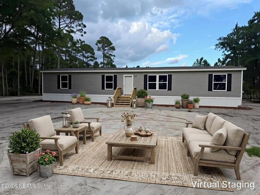 114 Nutmeg Trail Interlachen, FL 32148 - Photo 3 of 33 a view of a backyard with furniture potted plants and wooden fence