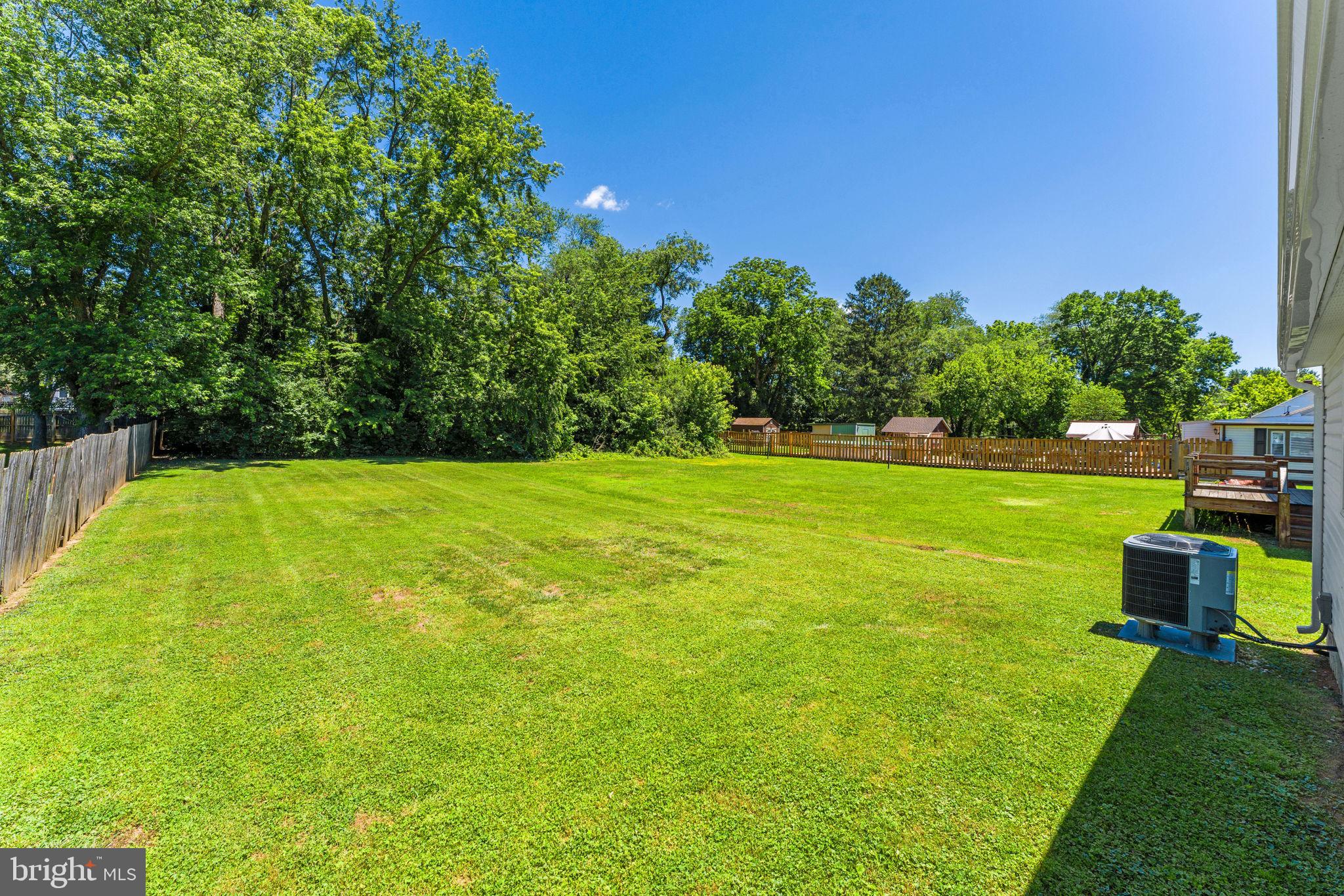 216 Walnut Street Berryville, VA 22611 - Photo 35 of 36 a view of a garden with a building in the background