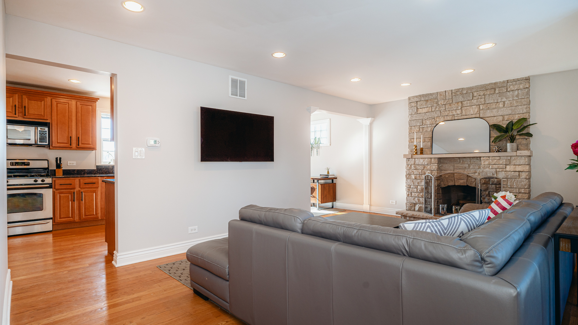 241 Devon Avenue Park Ridge, IL 60068 - Photo 6 of 46 a living room with furniture a flat screen tv and a fireplace