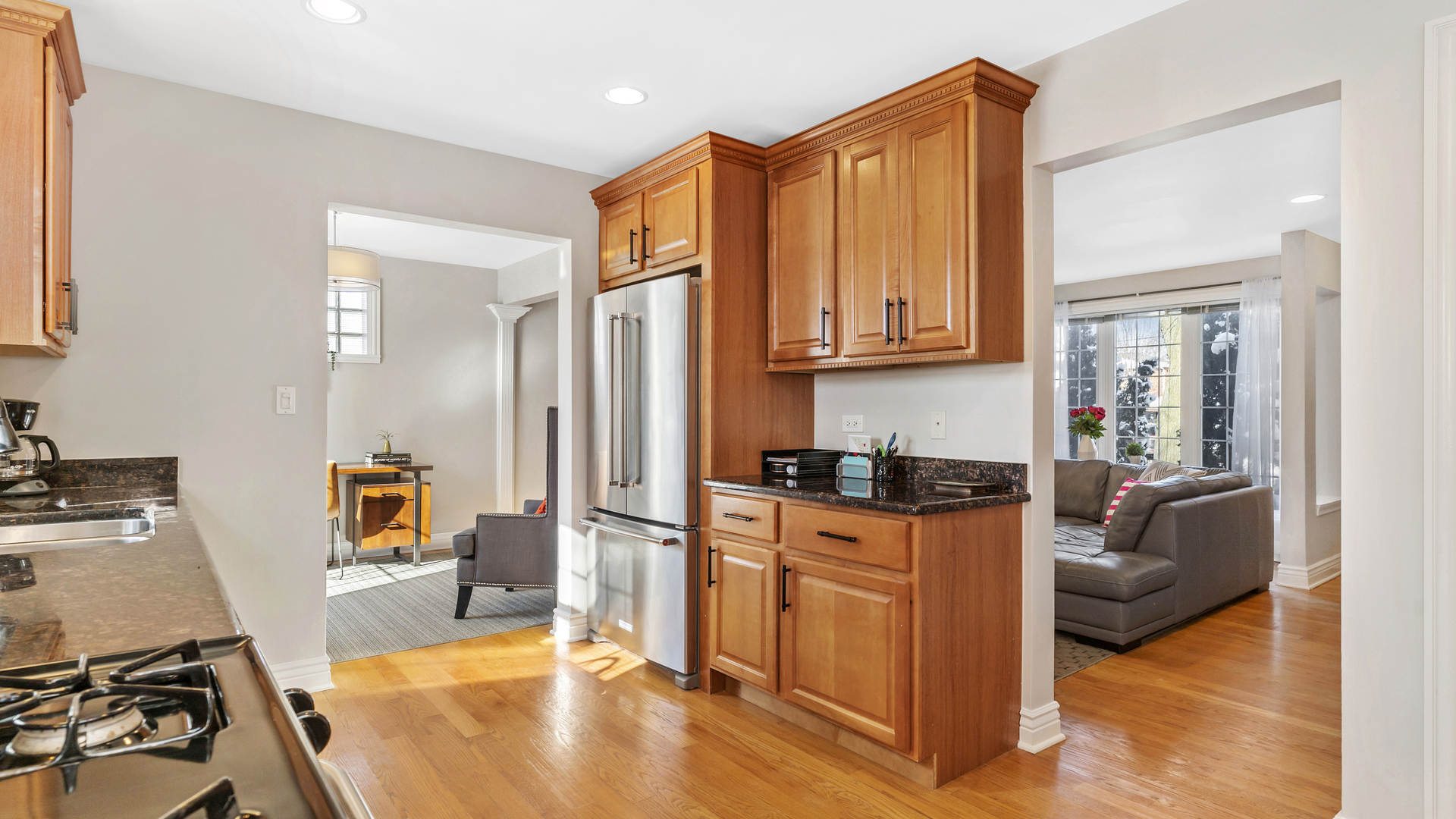 241 Devon Avenue Park Ridge, IL 60068 - Photo 7 of 46 a kitchen with stainless steel appliances granite countertop a stove top oven a sink dishwasher and cabinets with wooden floor