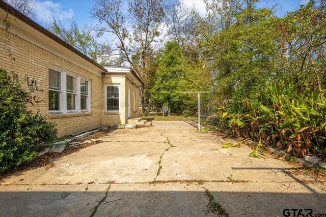 a view of a house with snow on the road