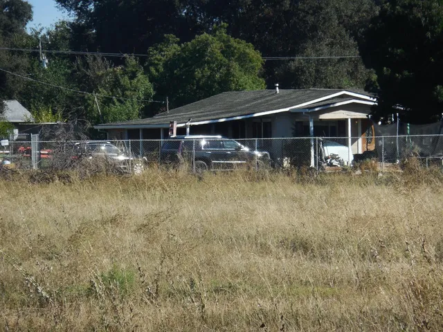 a backyard of a house with small yard and outdoor seating