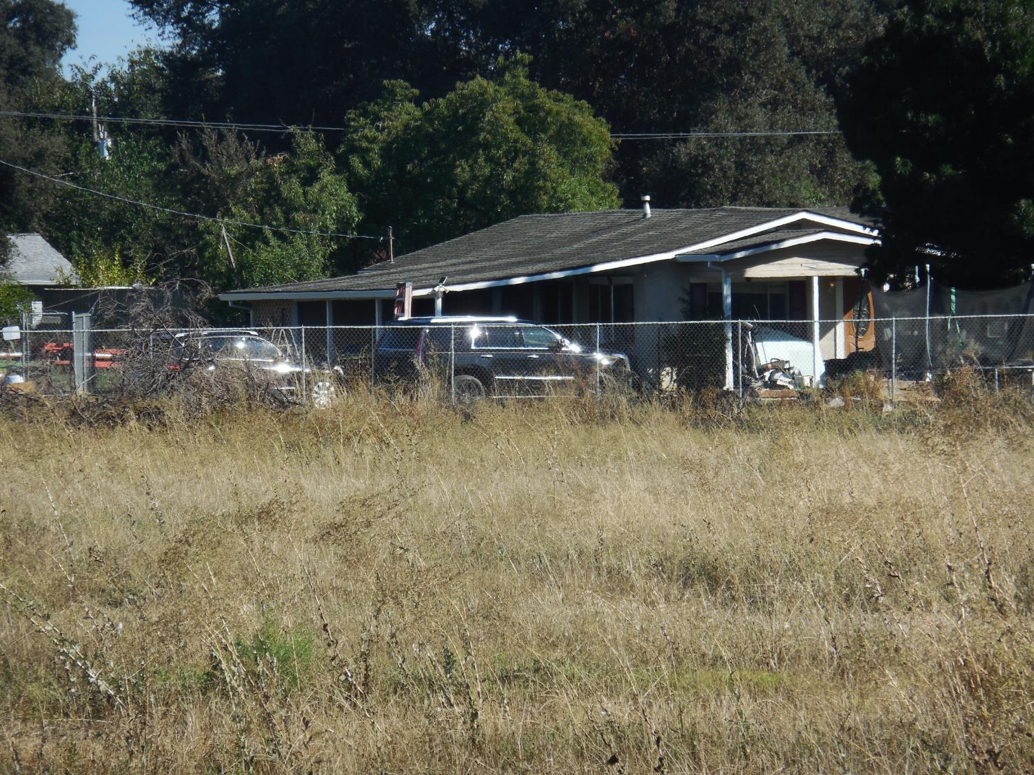10118 Luther Road Live Oak, CA 95953 - Photo 2 of 5 a backyard of a house with small yard and outdoor seating
