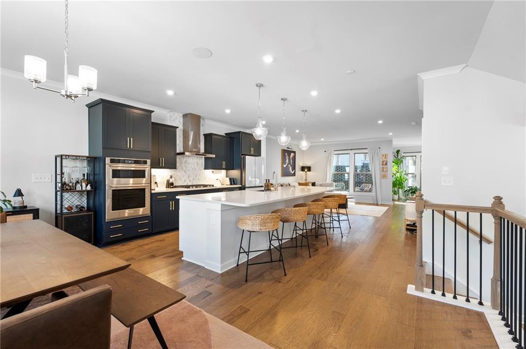 1320 Stanley Park Drive, Unit 141 Decatur, GA 30033 - Photo 12 of 71 a kitchen with stainless steel appliances granite countertop a refrigerator a oven a sink a dining table and chairs with wooden floor
