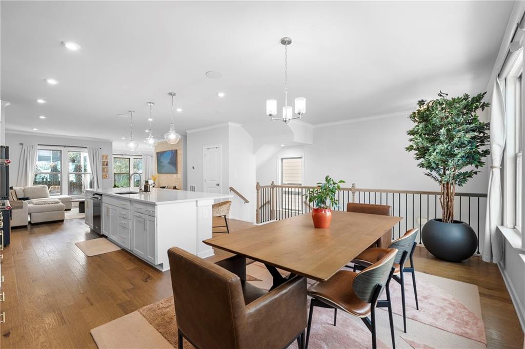 1320 Stanley Park Drive, Unit 141 Decatur, GA 30033 - Photo 8 of 71 a view of a dining room and livingroom with furniture wooden floor a rug a potted plant and a chandelier