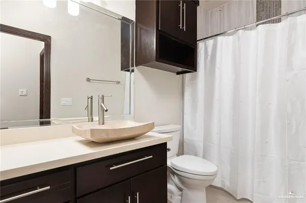 a bed sitting in a bedroom next to a window with wooden floor
