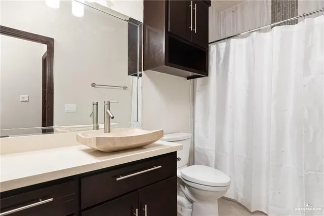 a bed sitting in a bedroom next to a window with wooden floor