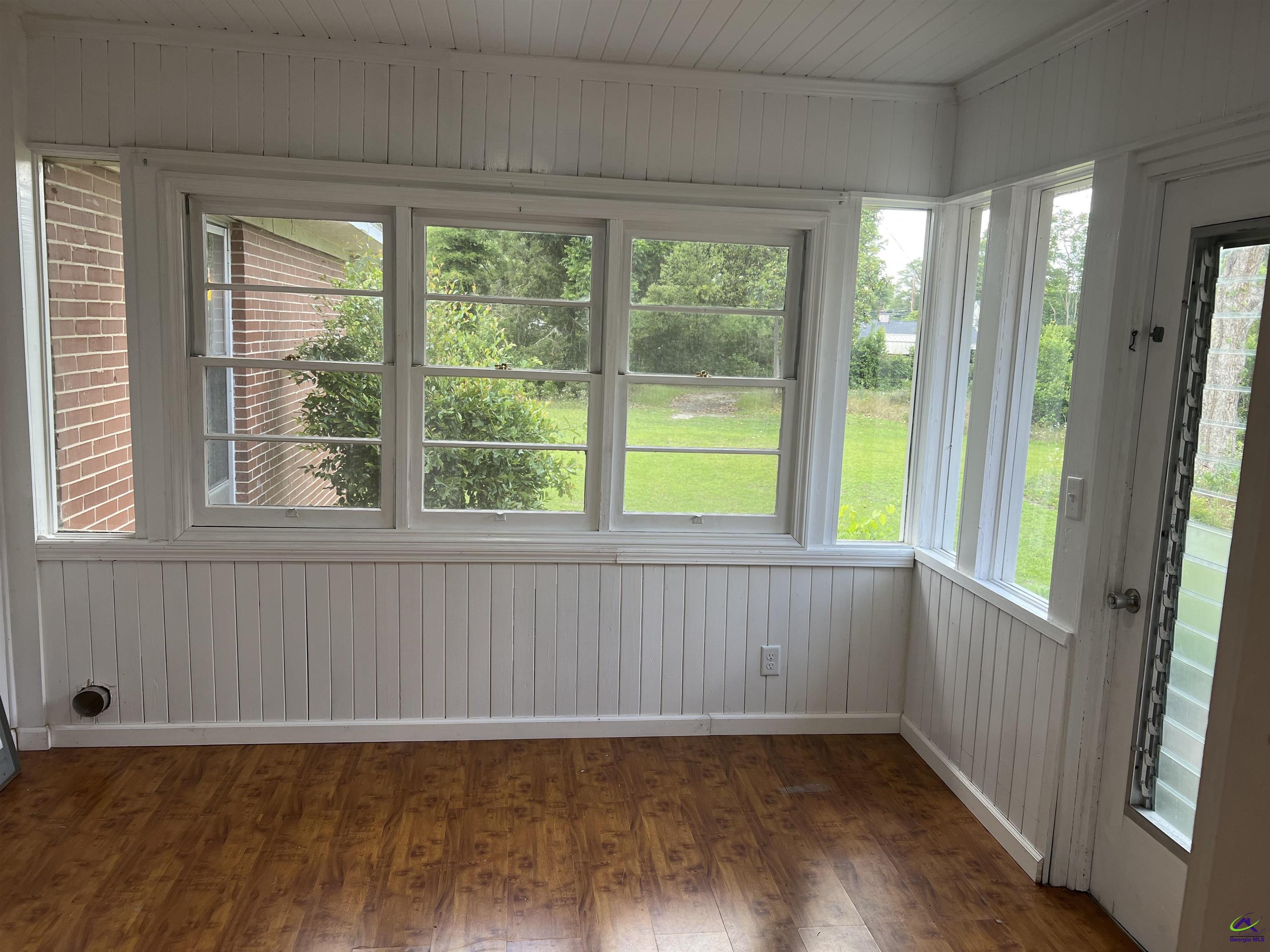145 South 2nd Street Cochran, GA 31014 - Photo 14 of 24 a view of an empty room with wooden floor and a window