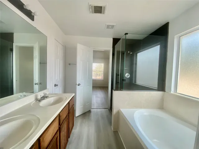 a bathroom with a bathtub and a sink