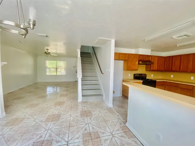 a view of a kitchen with furniture and staircase