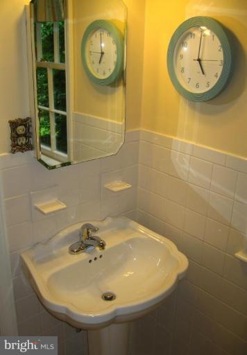 9919 Big Rock Road Silver Spring, MD 20901 - Photo 15 of 23 a bathroom with a sink and a mirror